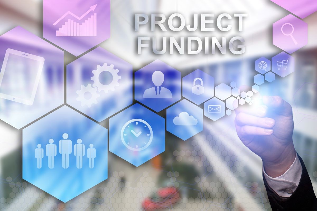 Businessman draws "Project Funding" on the virtual screen. Business concept. Internet concept.